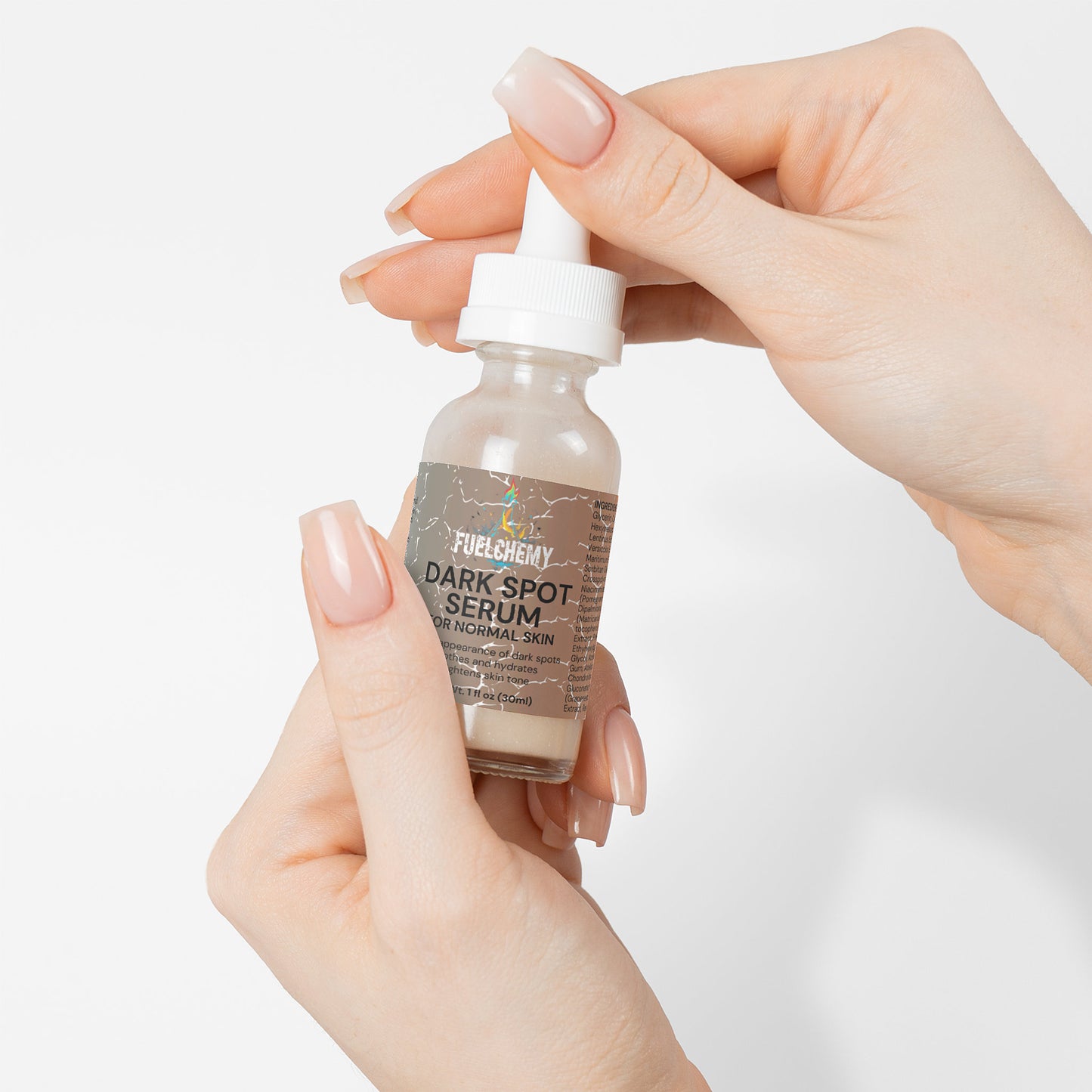Fuelchemy Dark Spot Serum for Normal Skin in a dropper bottle held by a hand