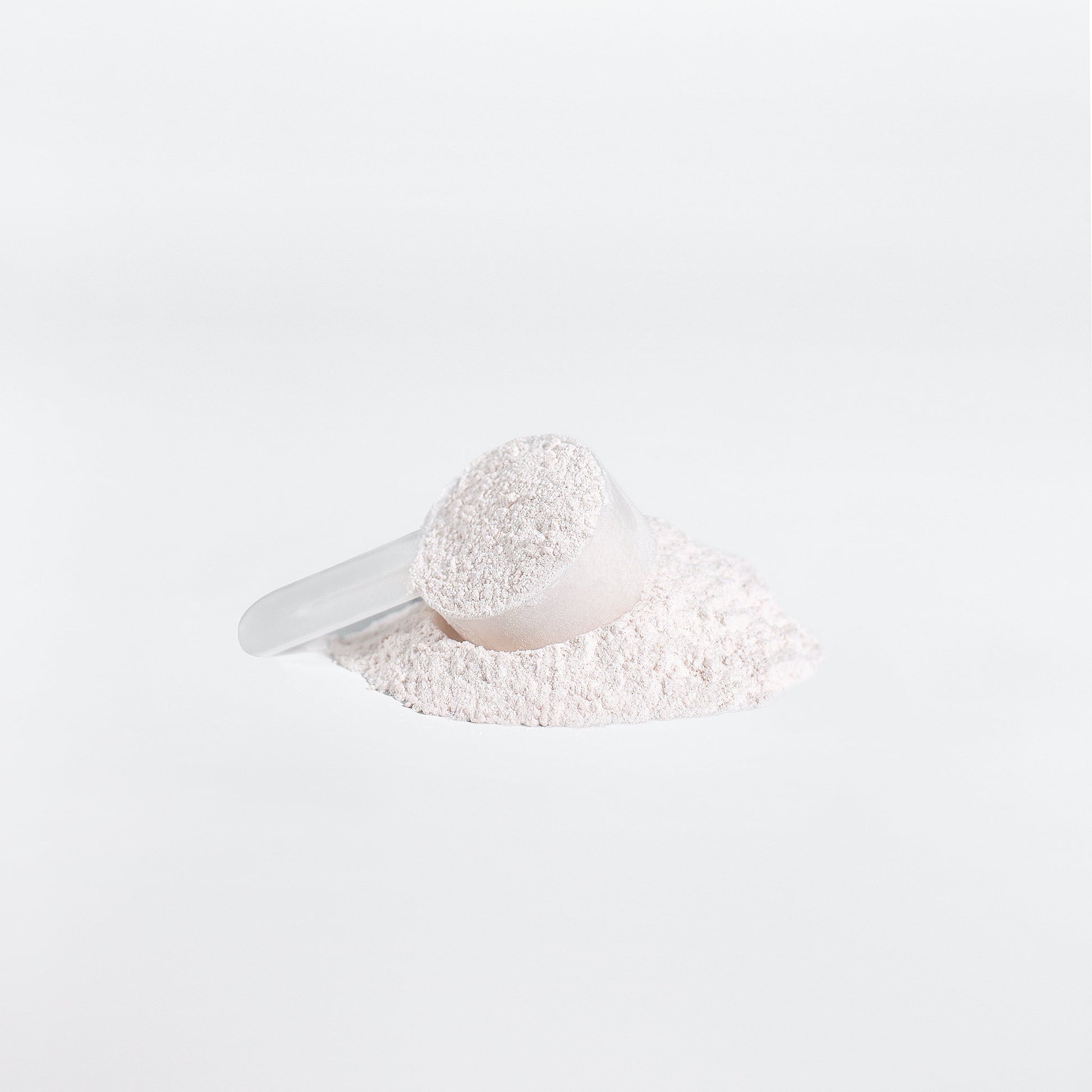 Fuelchemy Fruit Punch BCAA powder with a measuring scoop on a pile of fine powder