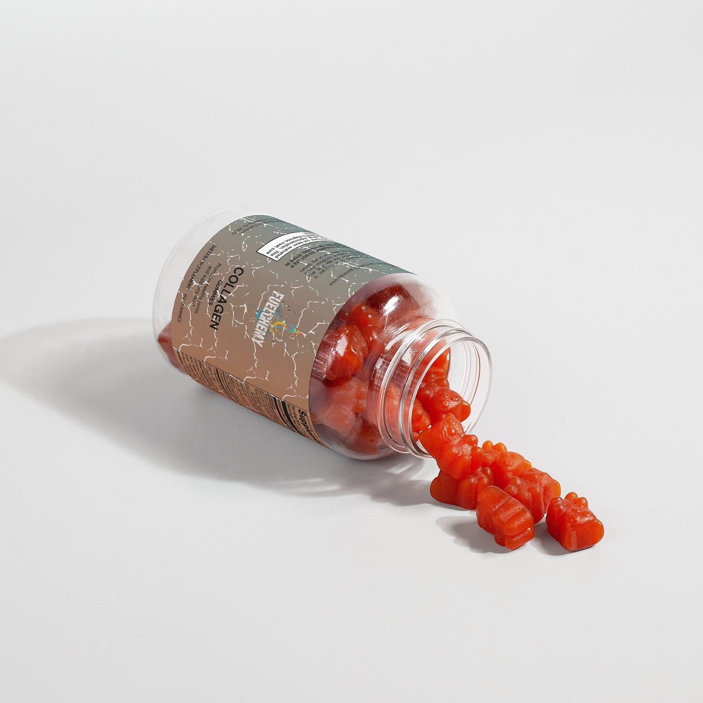 Fuelchemy collagen gummies for adults in a clear bottle, showcasing a few spilling out