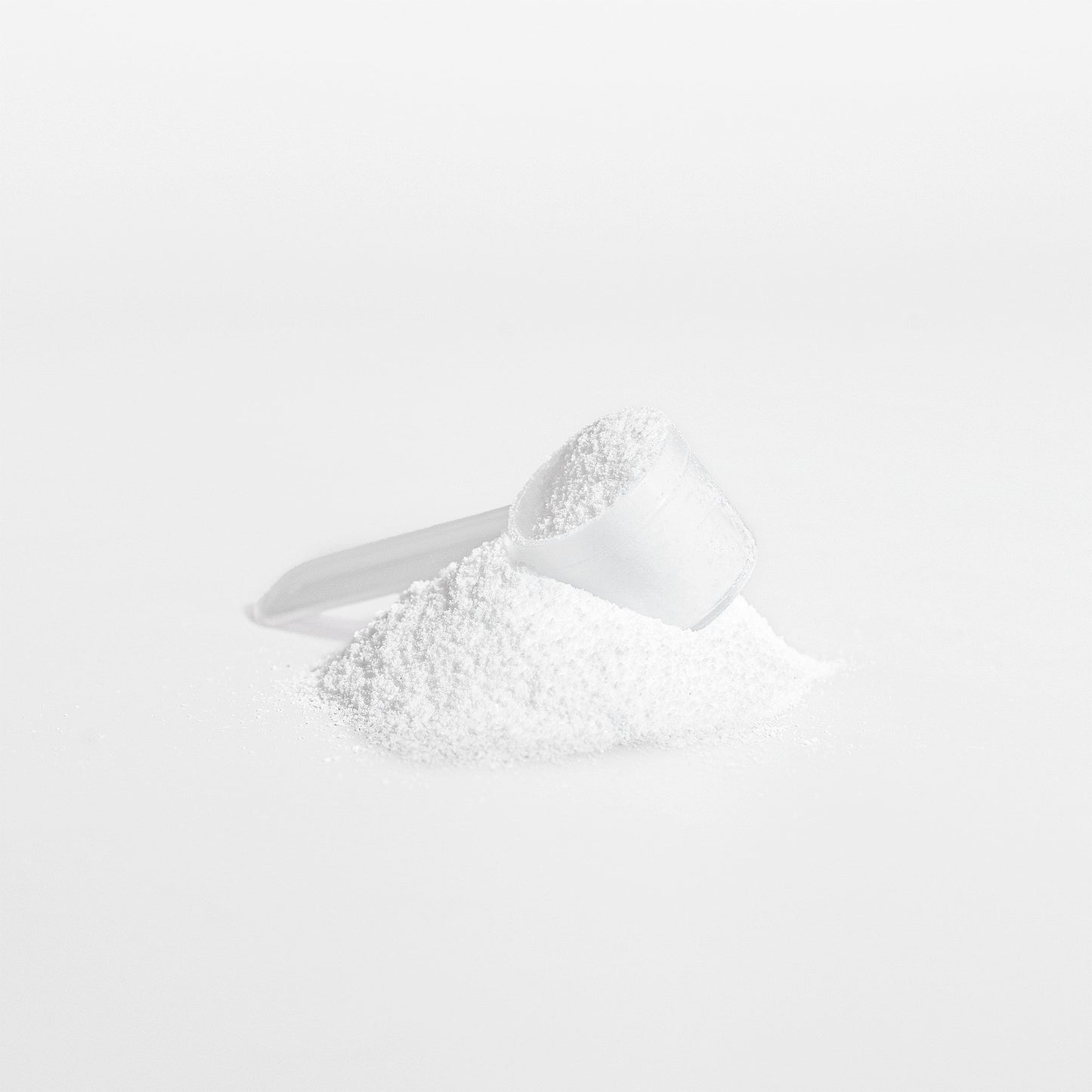 White Fuelchemy Creatine Monohydrate Powder for Athletes in a Measuring Scoop for Performance Boost