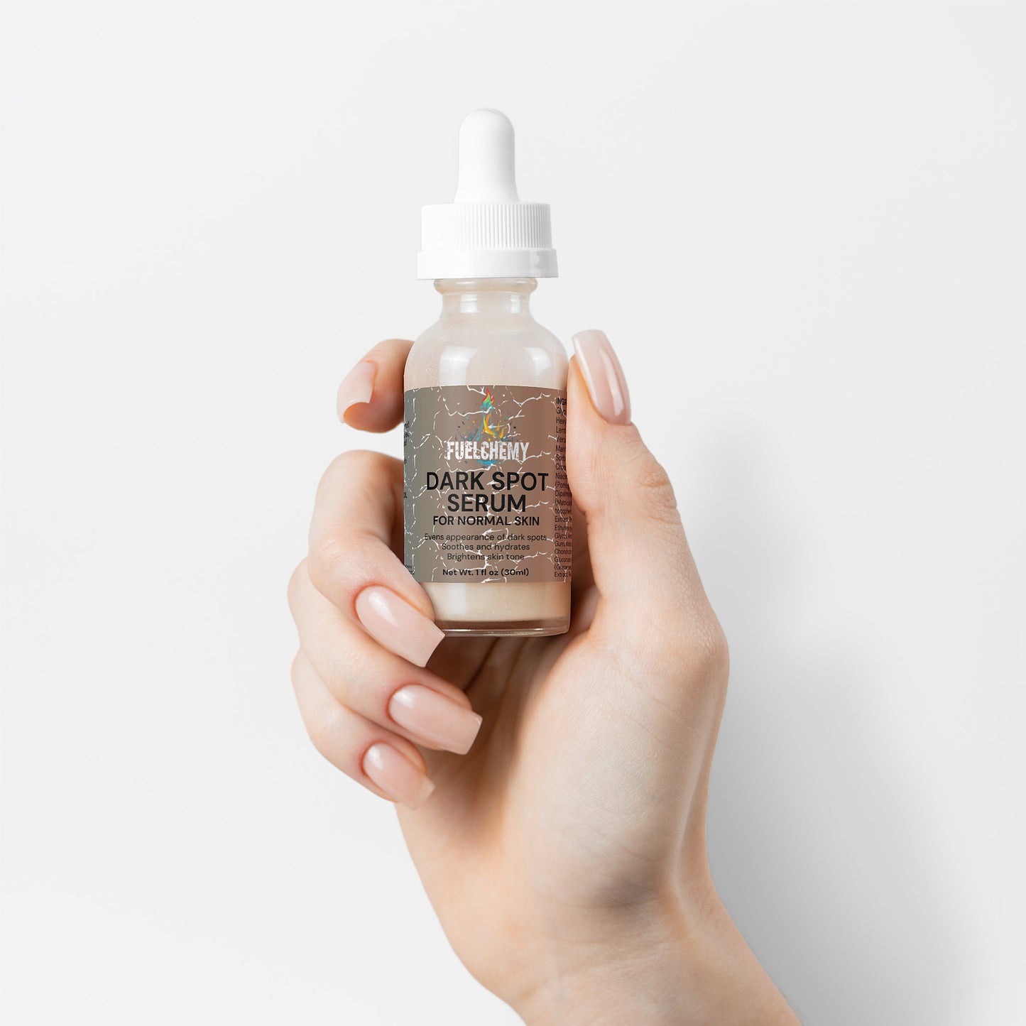 Fuelchemy Dark Spot Serum for Normal Skin in a dropper bottle held in a hand for skincare routines