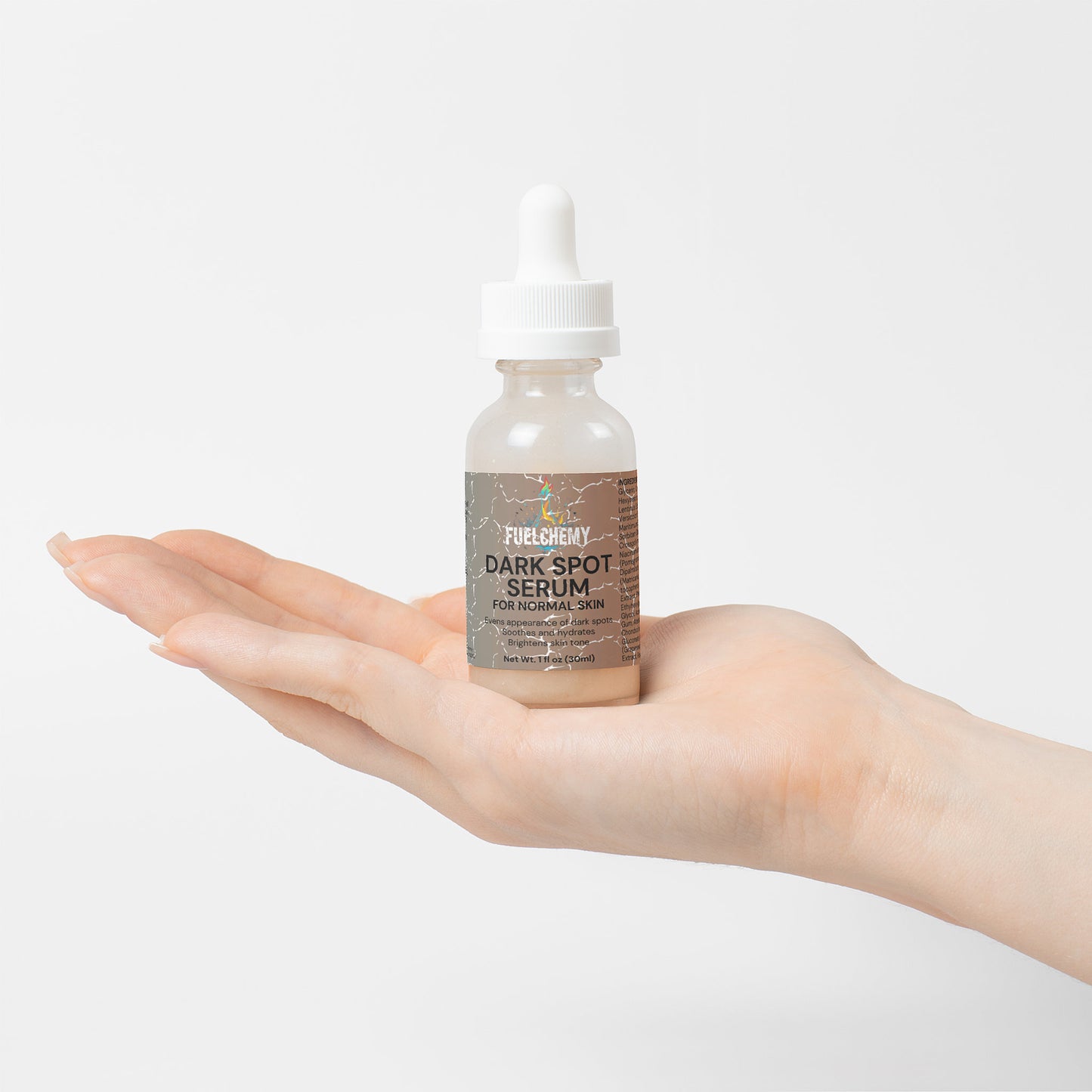 Fuelchemy Dark Spot Serum for Normal Skin in a dropper bottle on a hand