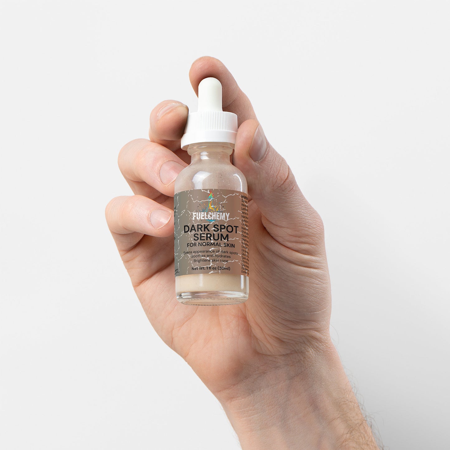 Fuelchemy Dark Spot Serum for Normal Skin in a glass dropper bottle held in a hand