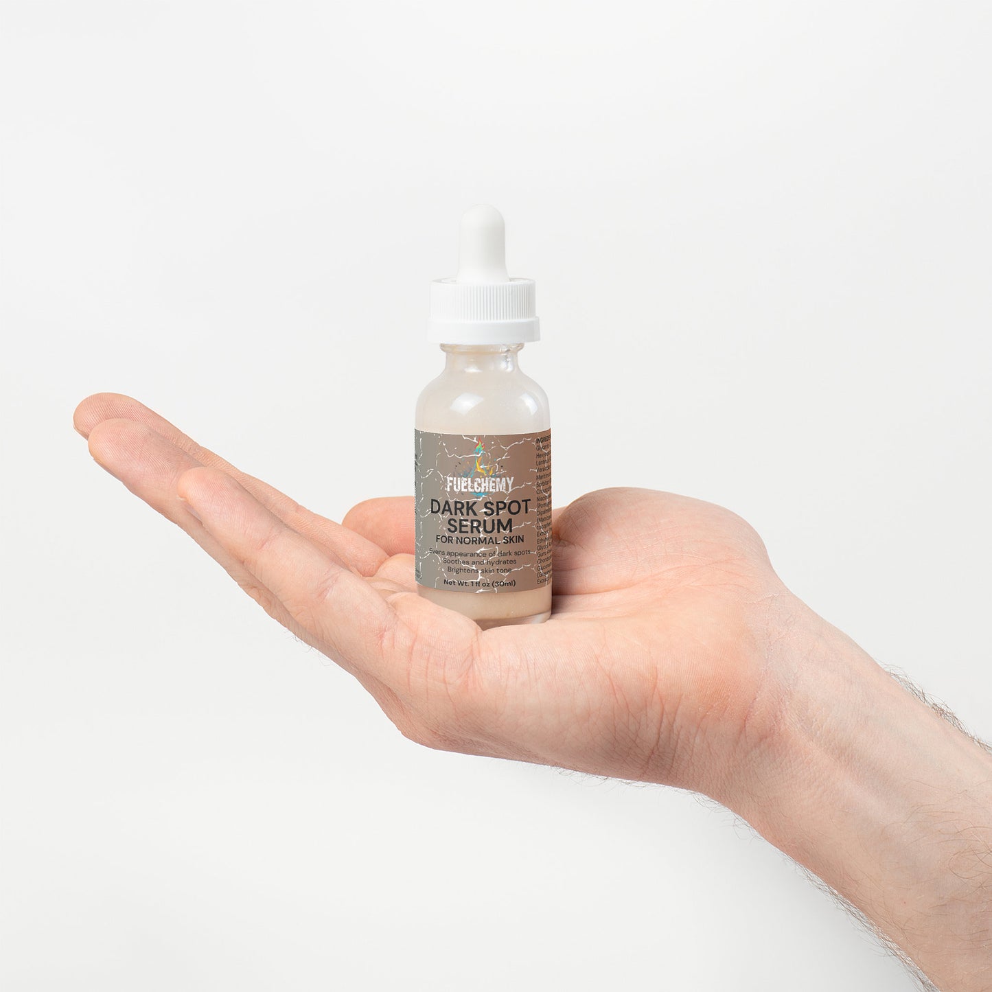 Fuelchemy Dark Spot Serum for Normal Skin in a dropper bottle held in a hand