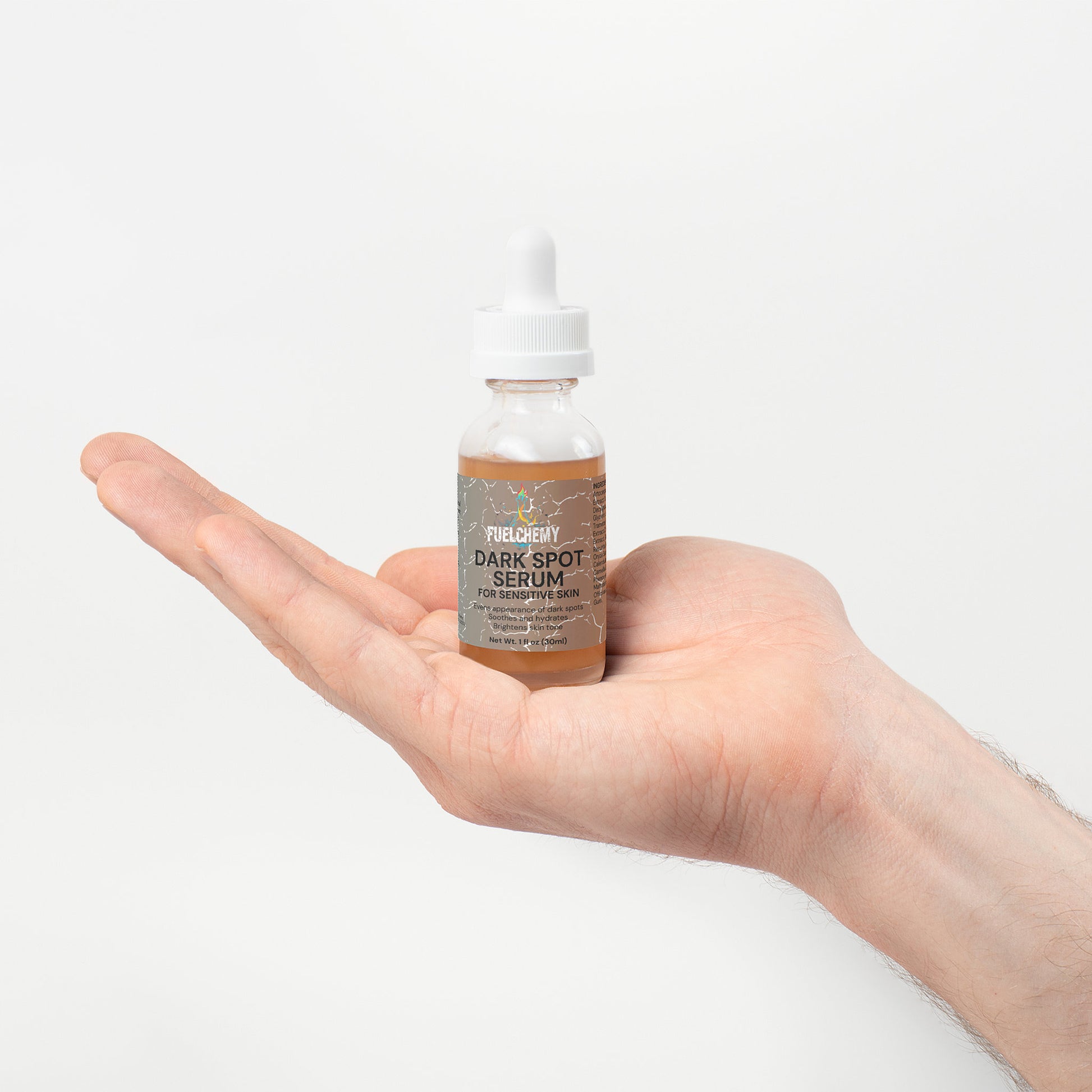 Fuelchemy dark spot serum sensitive skin in a dropper bottle held in a hand for targeted skincare treatment