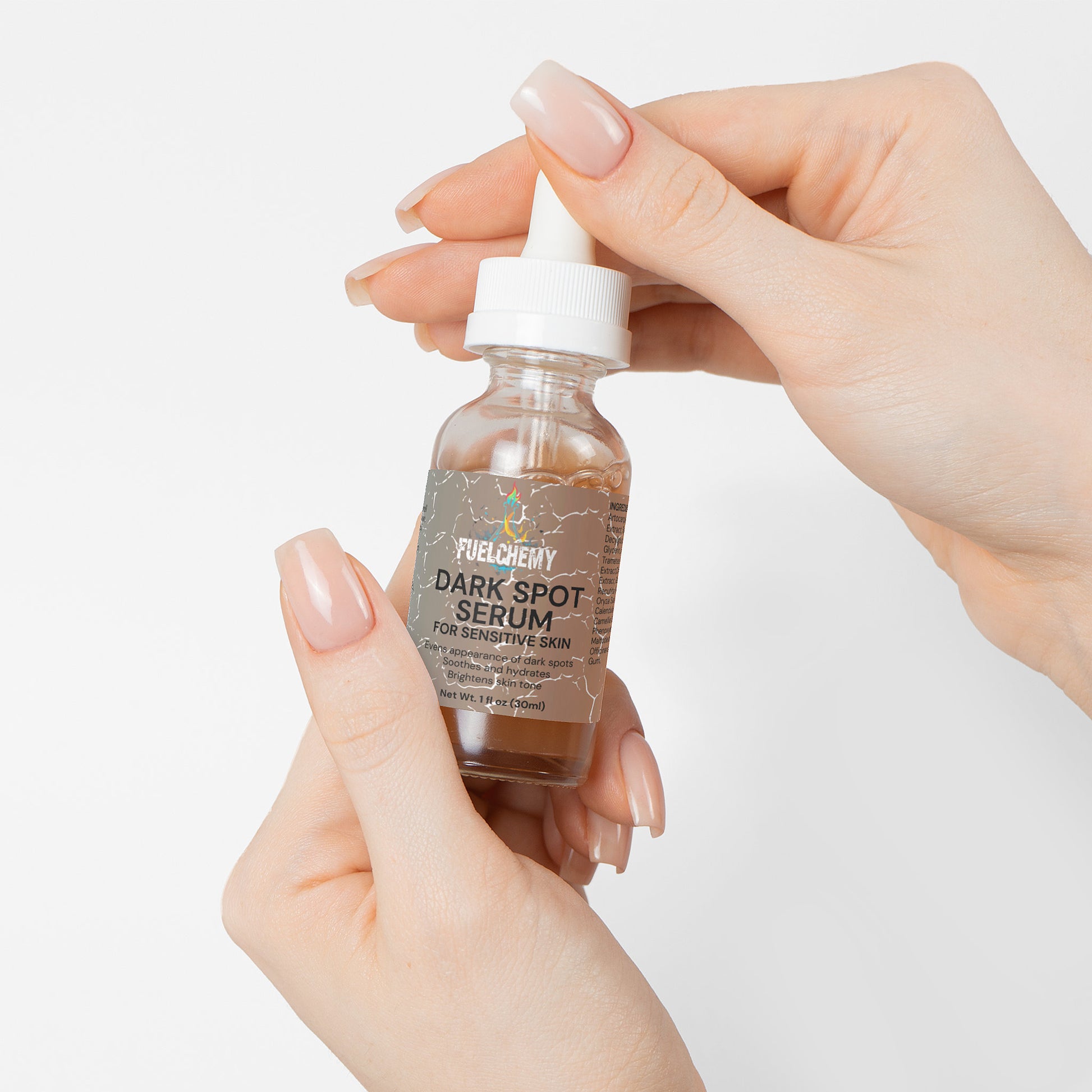 Fuelchemy Dark Spot Serum for Sensitive Skin in a glass dropper bottle held by delicate hands
