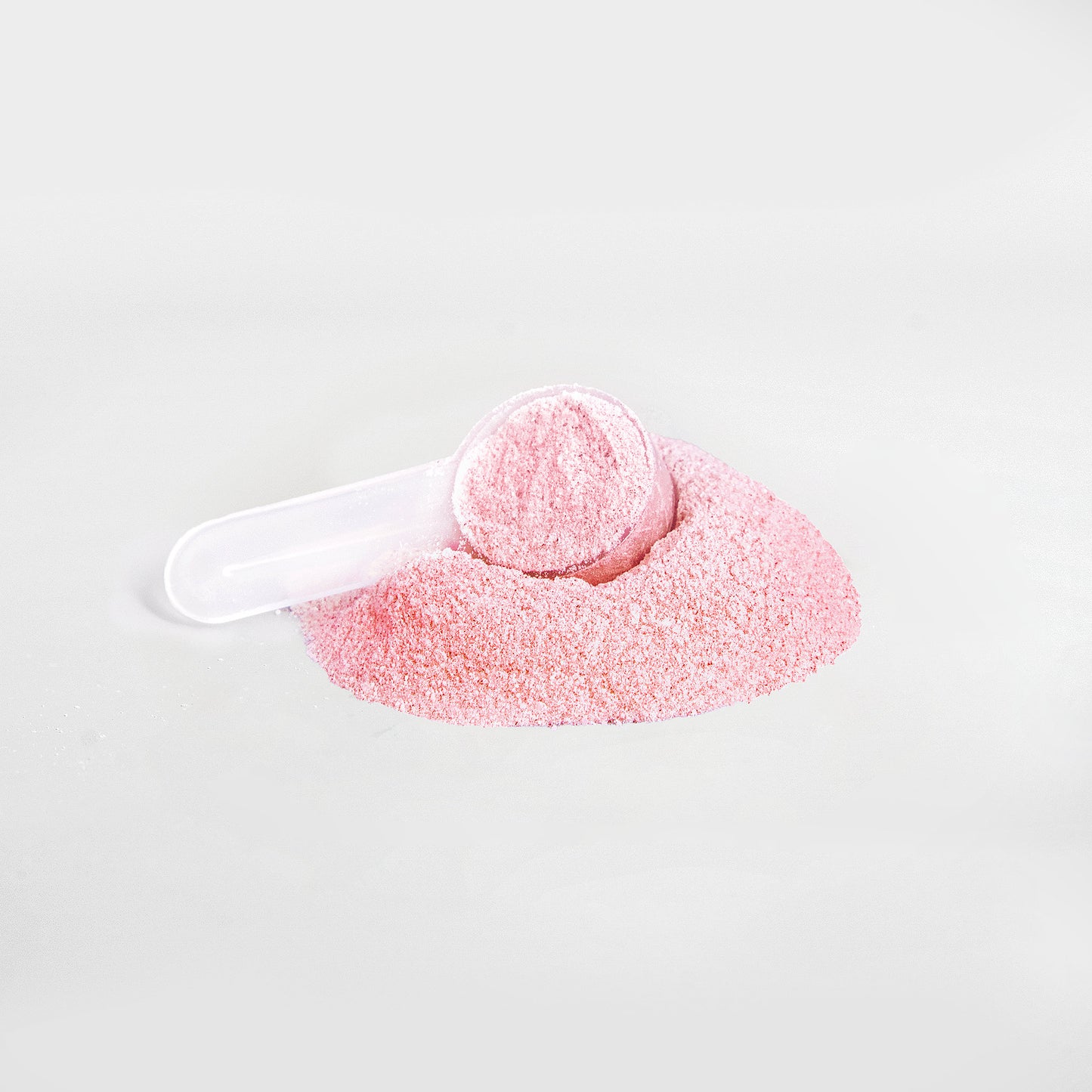 Fruit punch energy powder by Fuelchemy in a scoop on pink powder for enhanced performance