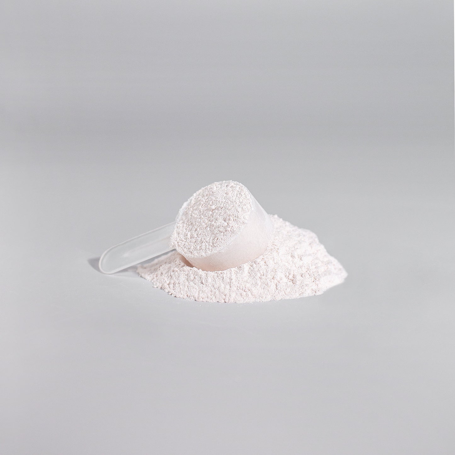 Fuelchemy high performance workout supplement powder in a scoop on a gray background