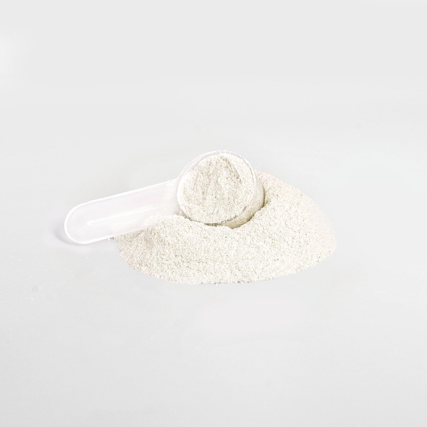 Yuzu energy powder drink in a white scoop on a pile of powder for energy enhancement